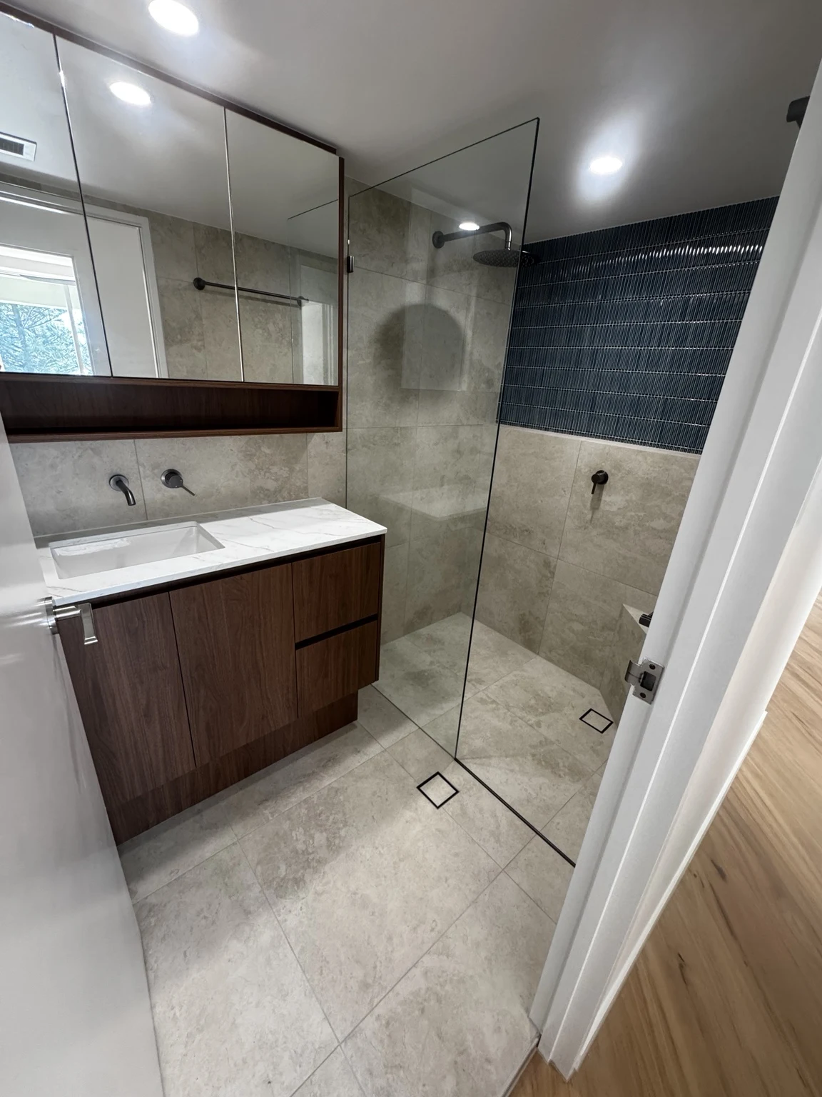 Bathroom with a timber vanity and glass shower