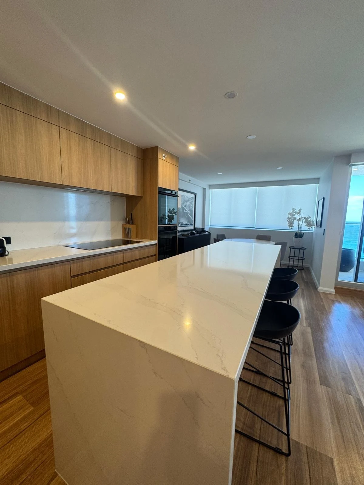 Kitchen with a stone island and timber cabinetry