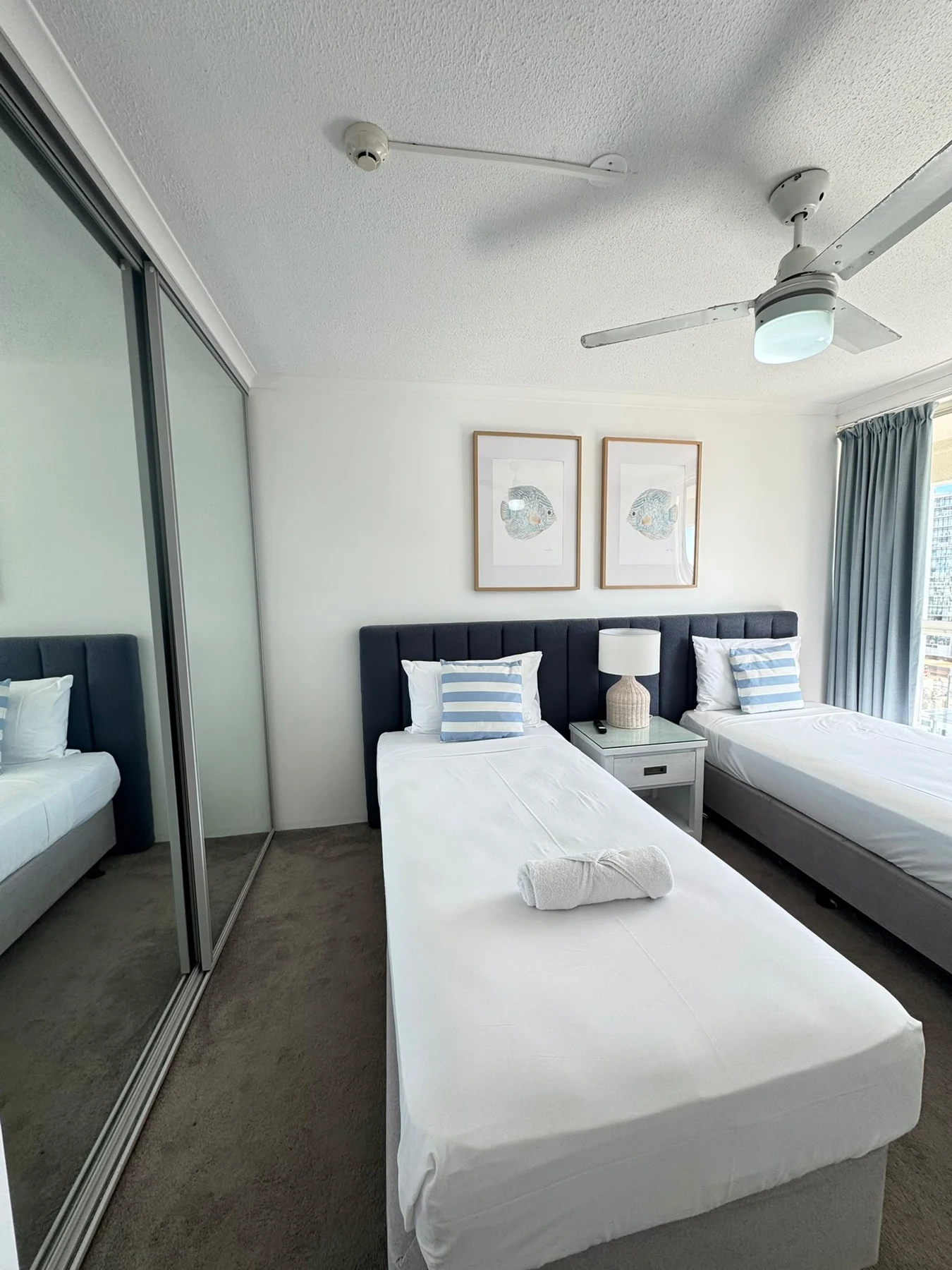 Twin bedroom with folded towels