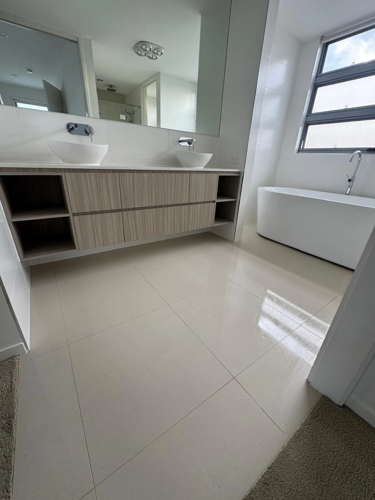 Double vanity and tiled bathroom floor