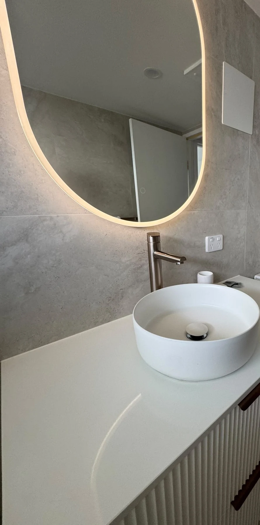 Bathroom vanity with backlit mirror